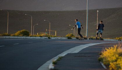 Skateboarder skateboarding on an open road doing freestyle tricks