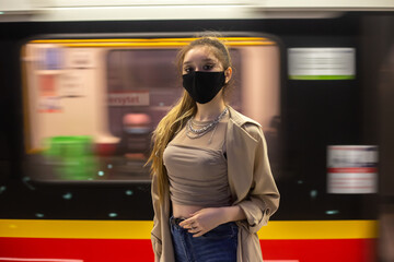 Woman in subway with protective mask