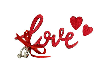 Lettering LOVE and red hearts from wood with wedding rings and satin bow