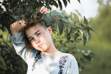 girl in gray dress picking berries