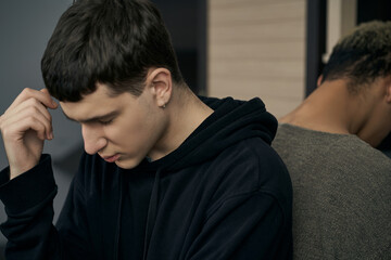 Staged photo illustrates problems and conflicts in gay couple relationships. Young upset and...