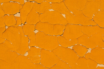 Old, cracked yellow concrete wall as background