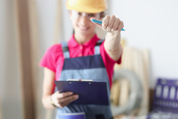 Smiling master builder holds pen and clipboard