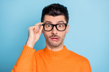Photo of young brown hair man amazed shocked surprised news fake novelty hand touch eyeglasses...
