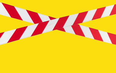 Red and white warning lines of barrier tape prohibit passage. Barrier tape on yellow isolate. Barrier that prohibits traffic. Danger unsafe area warning do not enter. Concept of no entry. Copy space