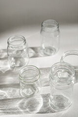 empty jars with shadow on white