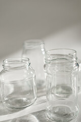 empty jars with shadow on white