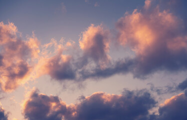 Beautiful dramatic sky with dark clouds at sunset, natural abstract background texture.