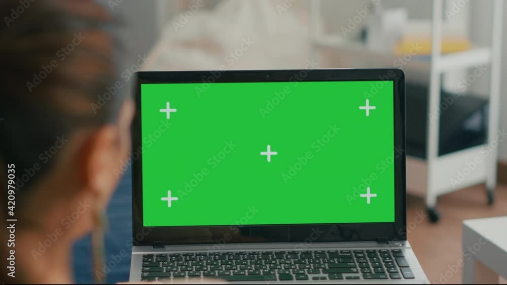Poster close up of laptop computer with mock up green screen chroma key display. business woman lying on so