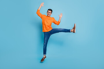 Full size photo of young excited man happy positive smile wave hands hello jump up isolated over...
