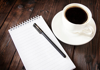 coffee and notepad on wooden background