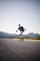 Obraz premium Close up image of a skateboarder skating his skateboard down the road.
