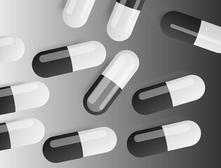 the capsules are scattered on a black and white background
