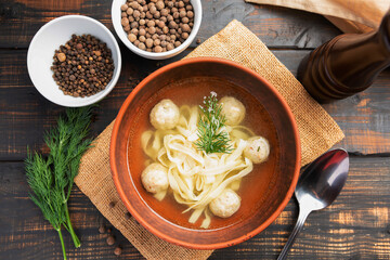 soup with noodles, meatballs and parsley and dill