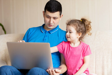 Caring father and daughter doing homework online. child preschooler studying online, using laptop. Man explaining to girl knowledge in computer. Distance Education e-learning homeschooling concept