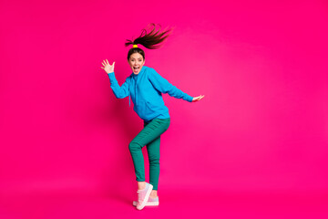 Fototapeta na wymiar Full length photo of charming pretty young lady wear blue sweater dancing isolated bright pink color background