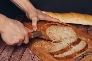 cutting a fresh loaf on a cutting board crispy bread kitchen meal