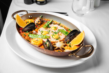 Spanish national cuisine dish paella with seafood and rice in a pan
