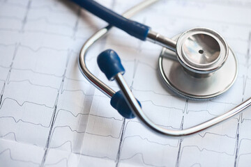 Medical concept. Cardiogram with stethoscope selective focus closeup background with copyspace.