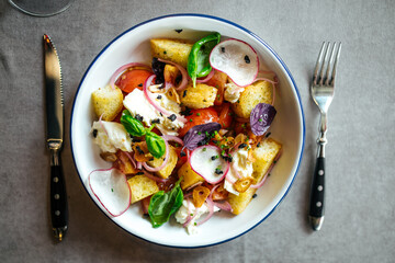 Gourmet organic salad with crackers and vegetables on the served table