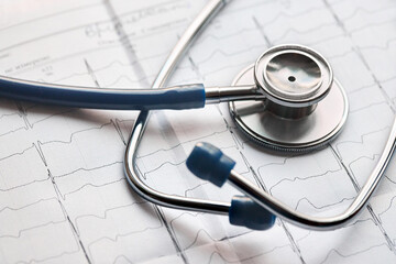 Medical healthcare concept. Cardiogram with stethoscope selective focus closeup background with copyspace.