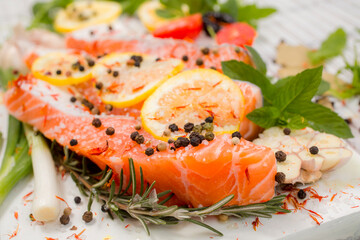 Fresh salmon fillets with spices ready for bakin