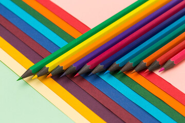 Many multicoloured pencils on colourful background