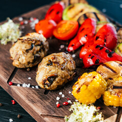 baked vegetables on a wooden board with spices