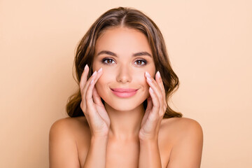 Photo of nice long hairdo optimistic lady without clothes touch face isolated on pastel beige color background