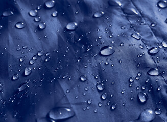 Water drops on waterproof membrane fabric. Detail view of waterproof cloth.