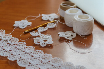 Crochet knitting. Lace of flowers.  Handmade Irish lace as a background