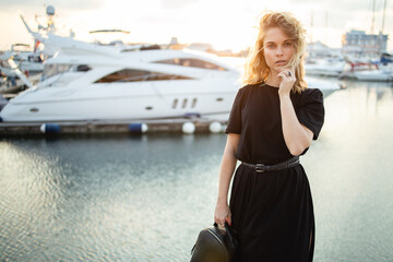 Girl in black dress on pier