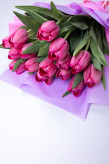 The tulips are wrapped in beautiful wrapping paper. Pink flower buds for the spring festival