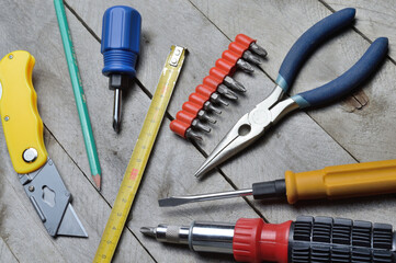 some home repair tools lie on a wooden background. close-up.