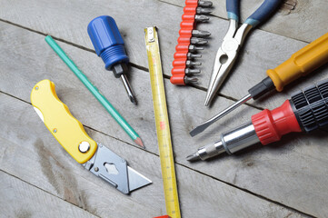 some home repair tools lie on a wooden background. close-up.