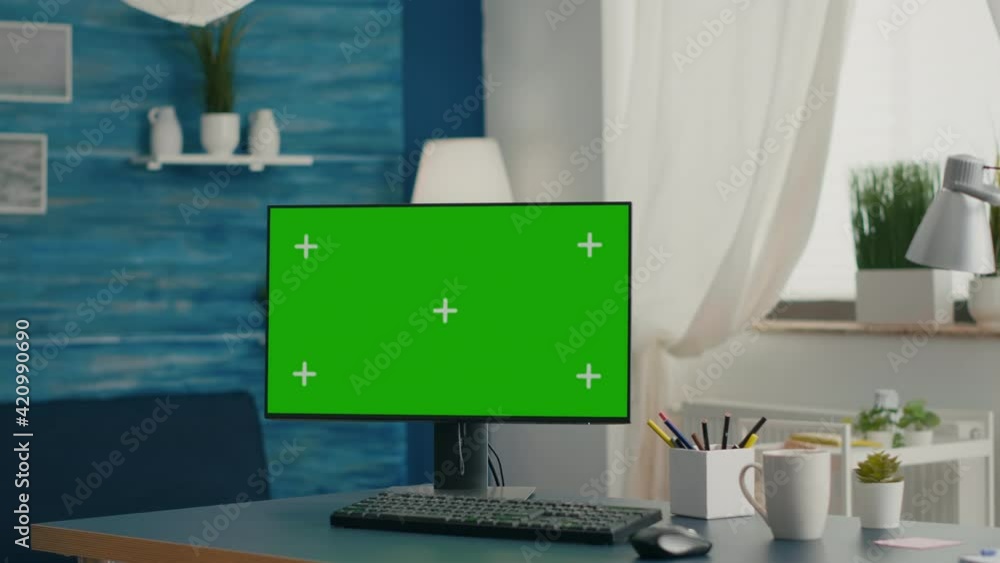 Poster desktop computer with mock-up green screen chroma key placed on desk in empty living room. pc with i