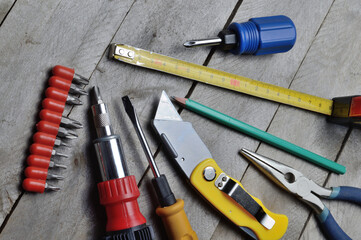 some home repair tools lie on a wooden background. close-up.