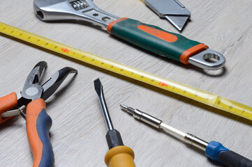 some home repair tools lie on a wooden background. close-up.
