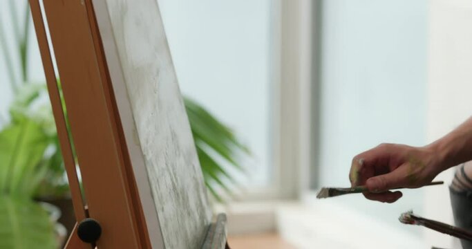 Young Chinese man painting at home,4K