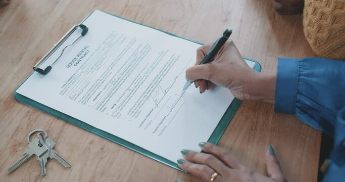 Woman signing rental house contract 