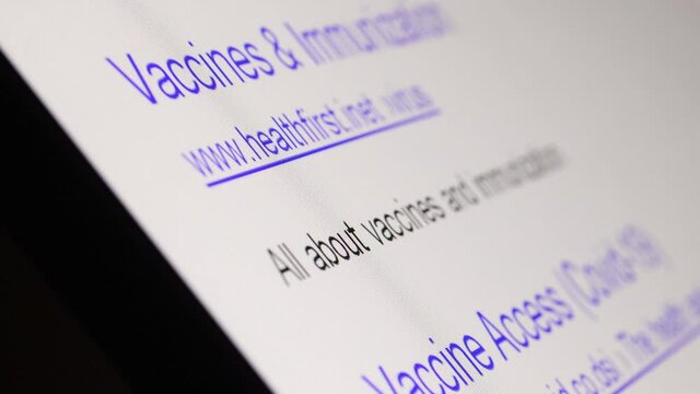Internet search results for coronavirus with The links of imaginary no-existing websites move on a display, close up.