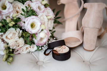 wedding bouquet, boutonniere, rings and shoes on white background