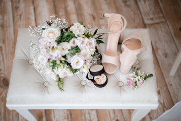 wedding bouquet, boutonniere, rings and shoes on white background