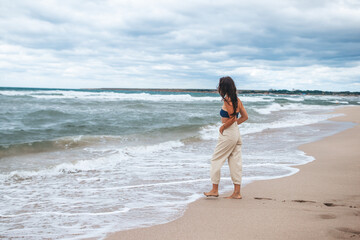 Fototapeta na wymiar Young happy woman on the beach