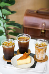 Basque cheesecake burnt bakery delicious cheesecake with 3 glassed of iced coffee on the table.