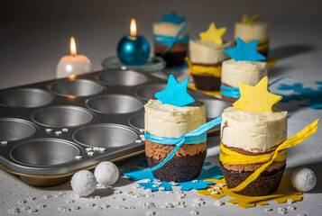 Triple chocolate mini cakes with blue and yellow decoration and muffin baking tray
