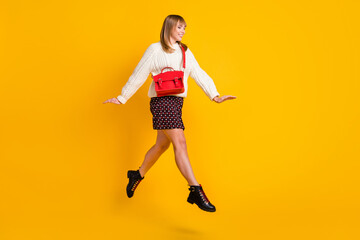 Fototapeta na wymiar Full body profile photo of cheerful pretty lady jump high running isolated on yellow color background