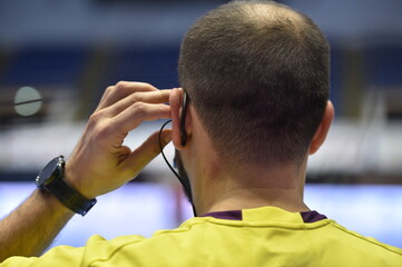 Detail with referee and earphone headset during a handball game - obrazy, fototapety, plakaty