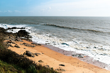 Rocky sandy coast of France on a sunny day, beautiful sea landscape.