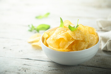 Potato chips in a white bowl
